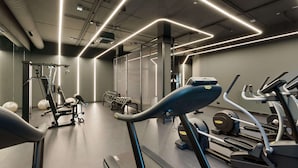 A modern gym with treadmills, weight machines, and exercise balls. - DoubleTree by Hilton Vienna Bosei (Vienna)