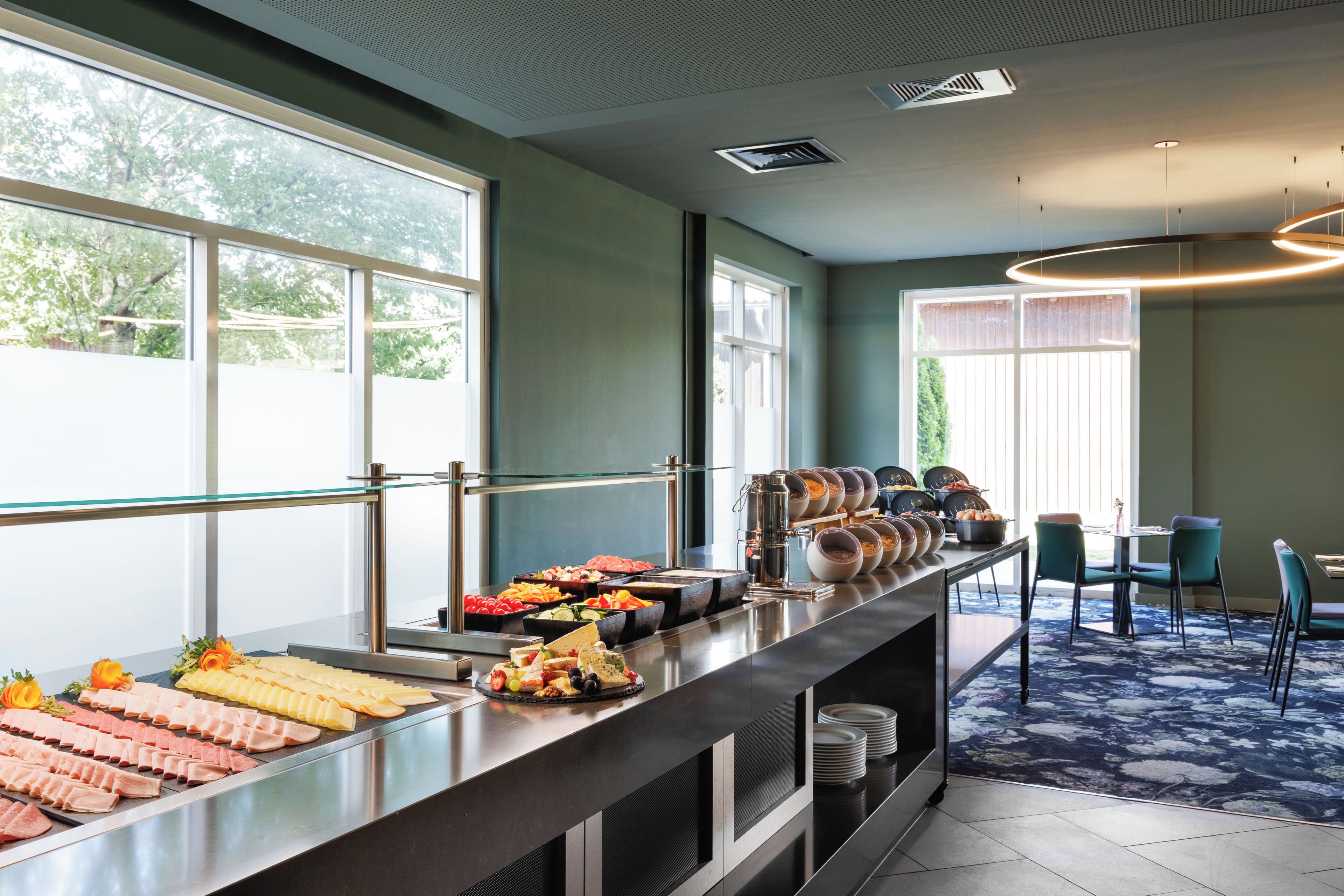 A buffet area with various food items and a seating arrangement with chairs and a table.