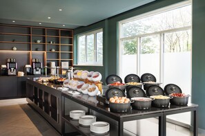 A buffet setup with various food items and a coffee station. - DoubleTree by Hilton Vienna Bosei (Vienna)