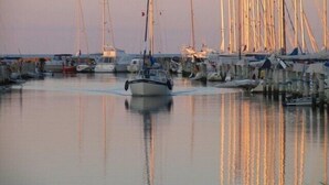 A marina with multiple boats docked at wooden piers.