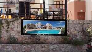 Un hotel con piscina, mobiliario exterior y una pared de piedra.