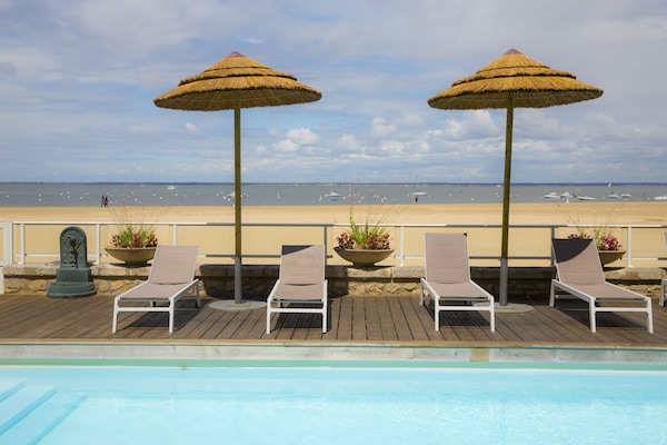 Seasonal outdoor pool, open 9:00 AM to 8:00 PM, pool umbrellas