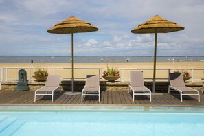 Seasonal outdoor pool, open 9:00 AM to 8:00 PM, pool umbrellas