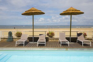 Seasonal outdoor pool, open 9:00 AM to 8:00 PM, pool umbrellas