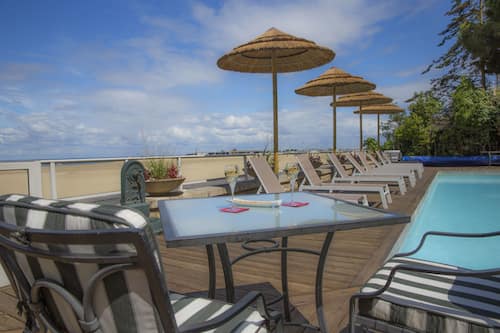 Seasonal outdoor pool, open 9:00 AM to 8:00 PM, pool umbrellas