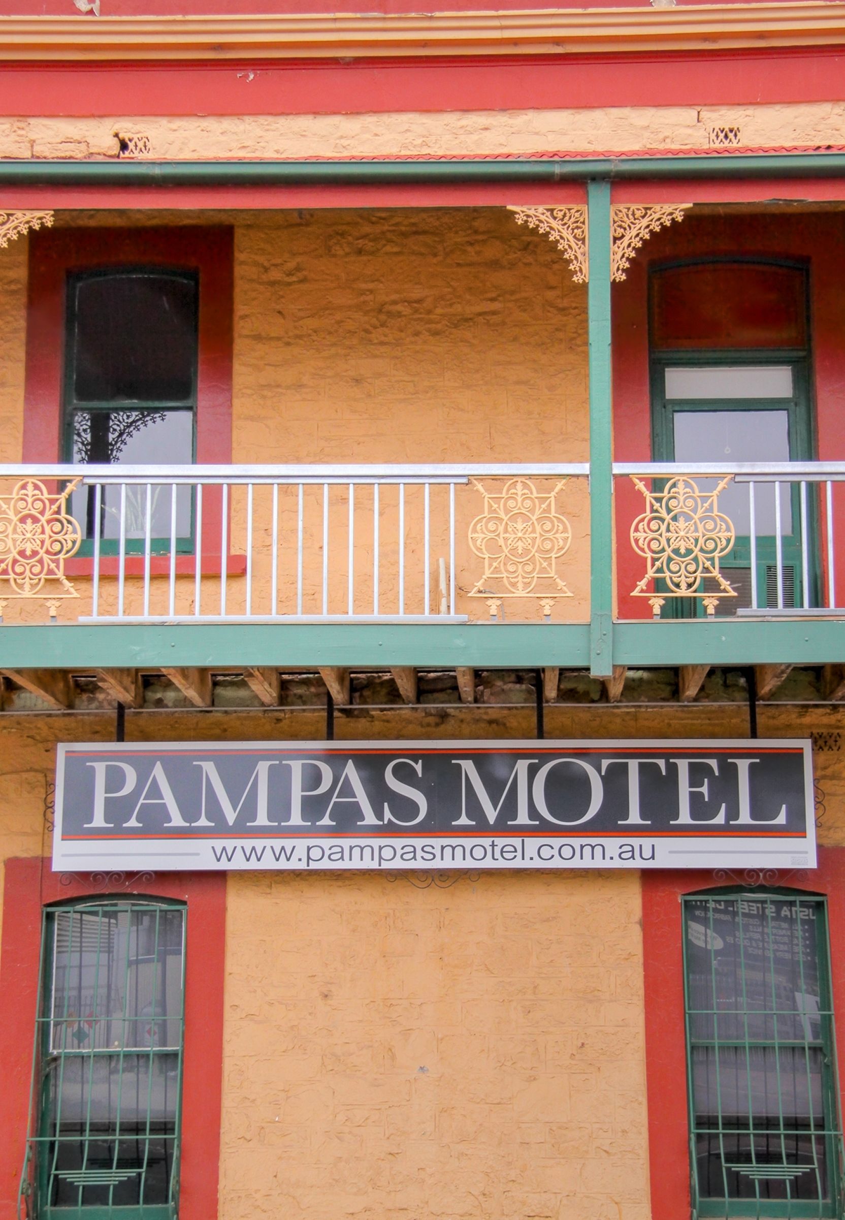 A building with a balcony and a sign that reads "Pampas Motel."