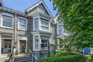 A Victorian-style building with multiple windows and a stone facade.