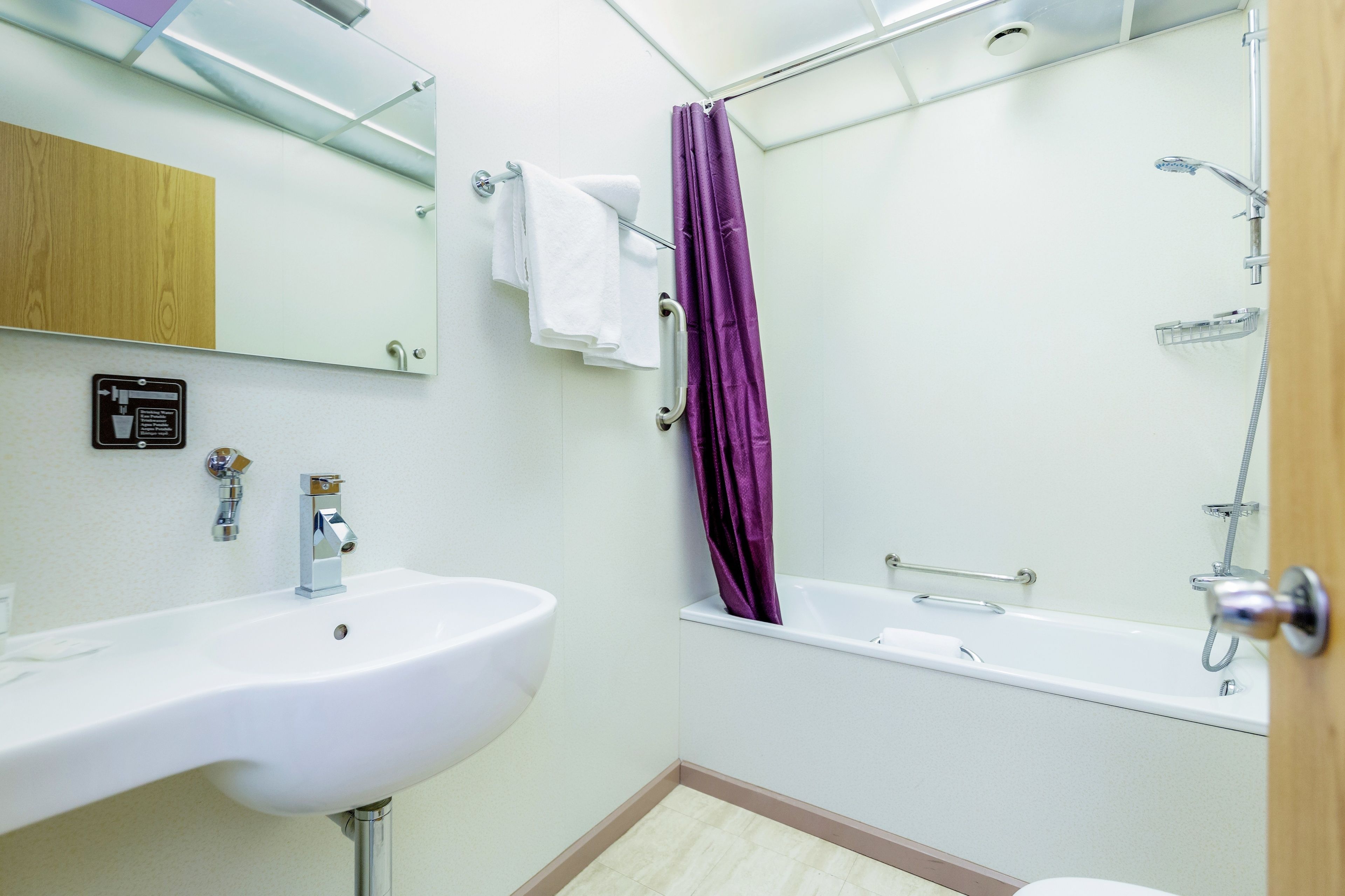 premier double room | bathroom | hair dryer, towels, soap, shampoo