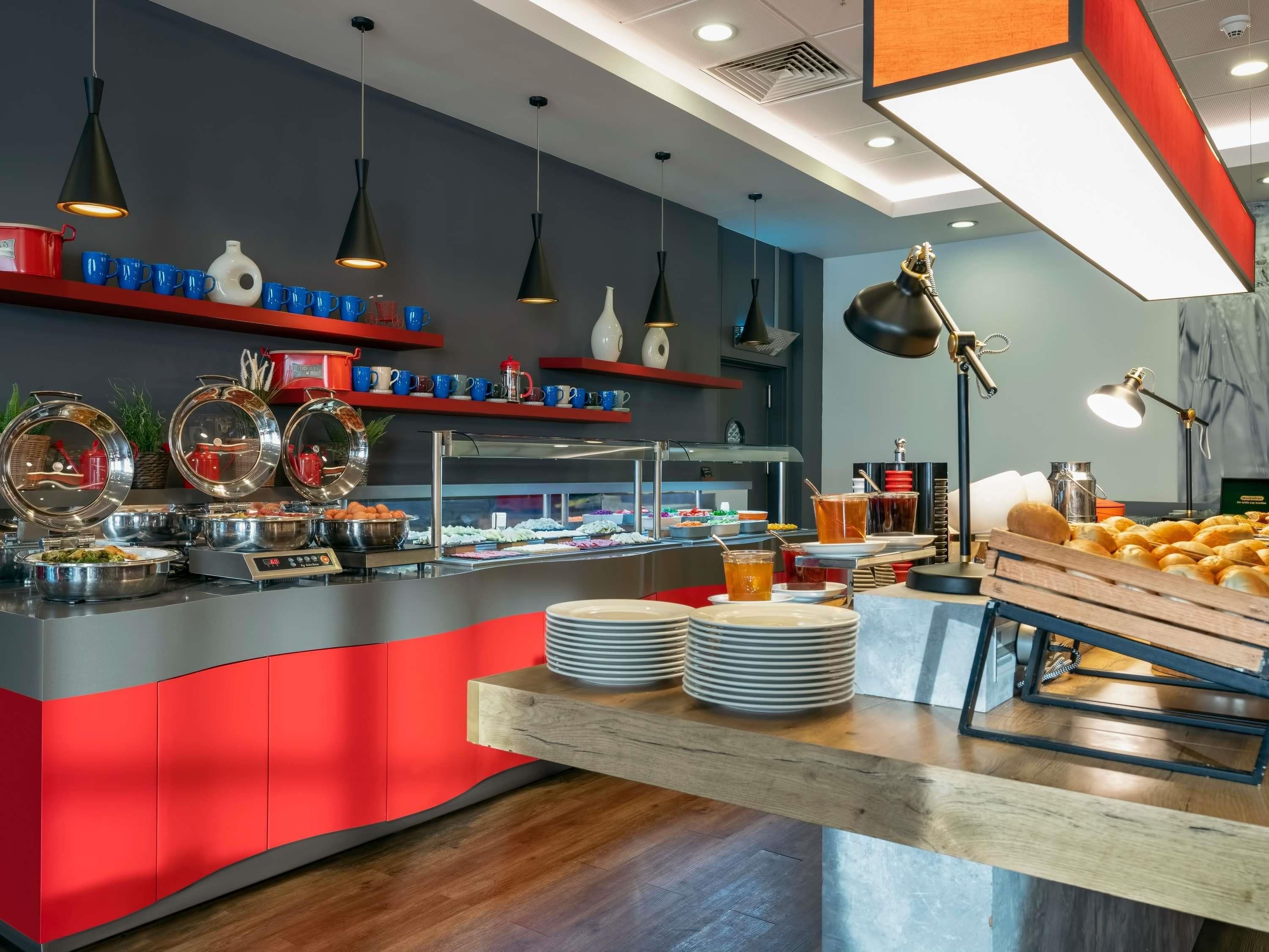 A buffet setup with various food items and utensils.