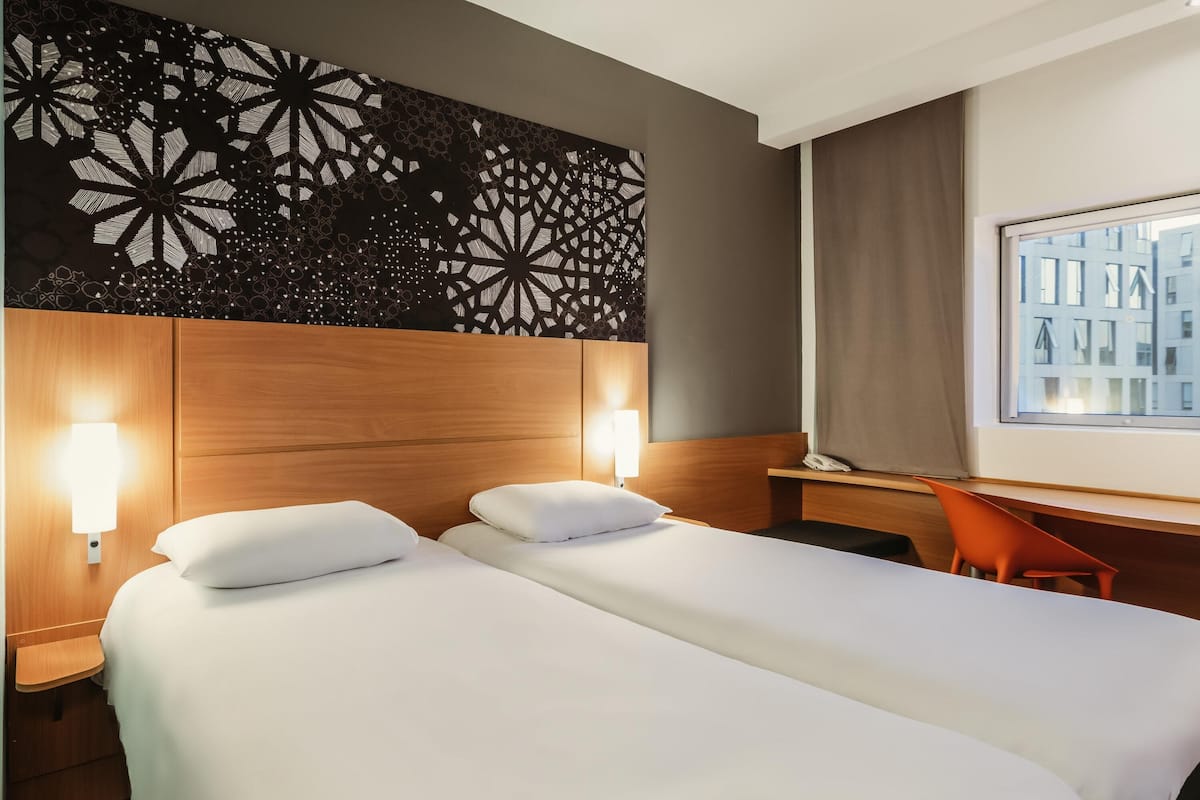 Premium bedding, desk, laptop workspace, blackout drapes