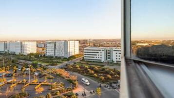 Premium bedding, desk, laptop workspace, blackout drapes