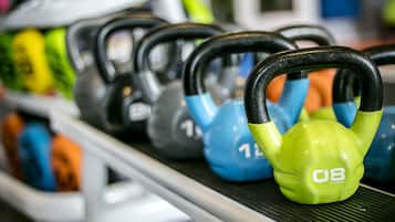 A row of kettlebells on a rack.
