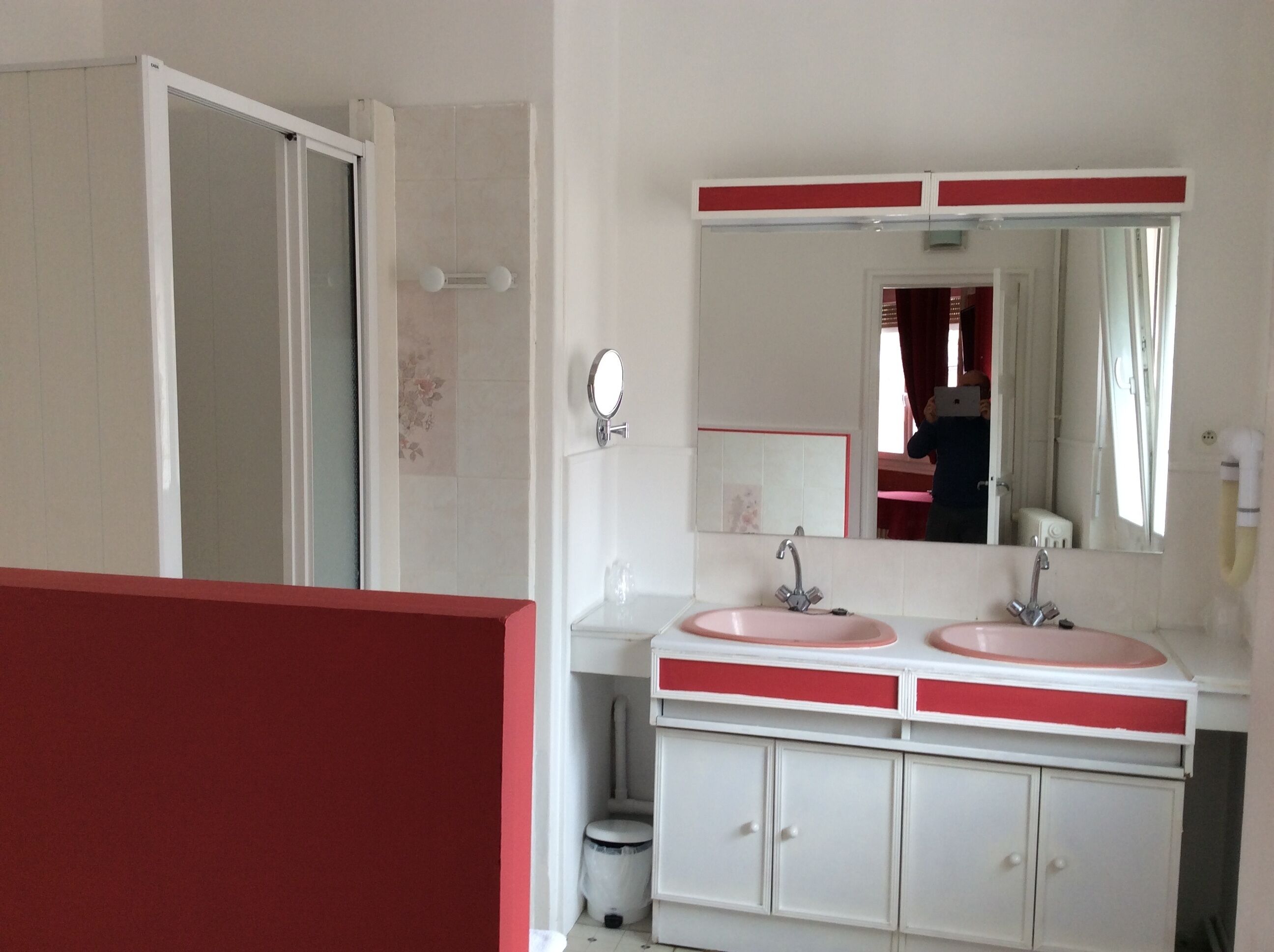 Une salle de bain avec deux lavabos, un miroir et des toilettes.