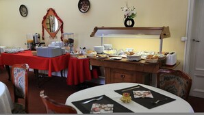 A breakfast buffet setup with various food items and a coffee station. - Hotel du Cygne (Beauvais)