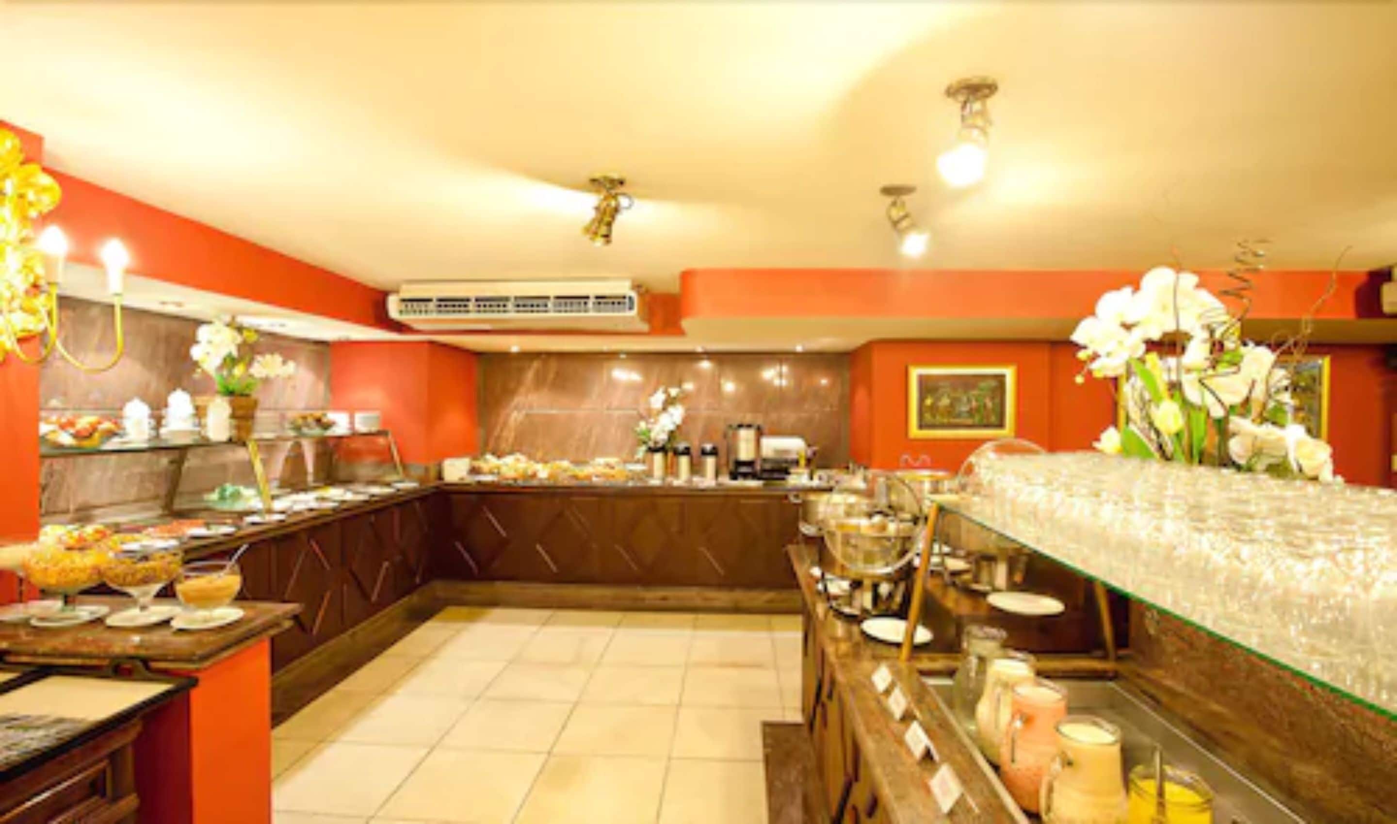 Una cocina de hotel con una barra de buffet, que incluye diversos alimentos y una estación de café.