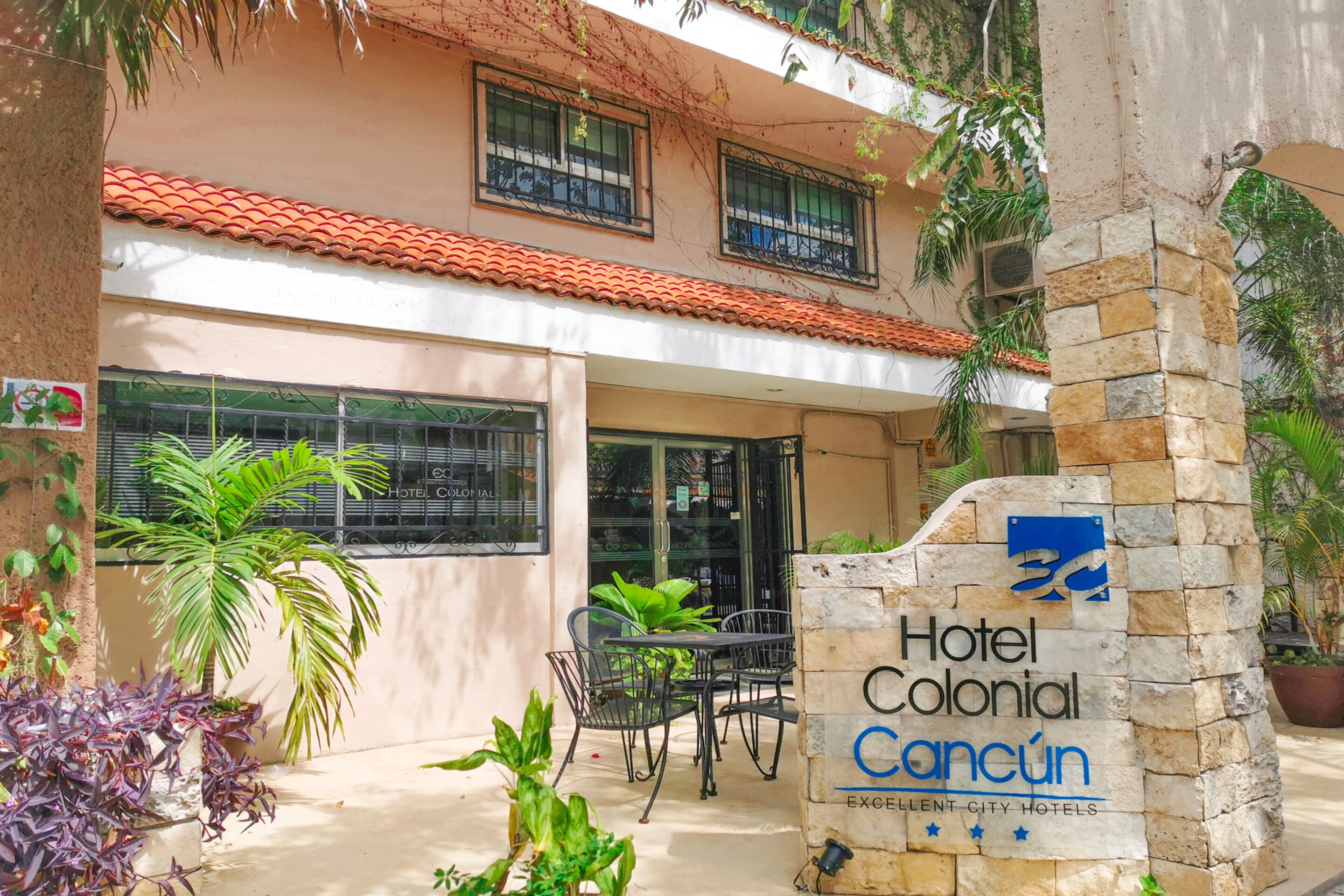 Hotel Colonial Cancun with a patio area featuring outdoor seating and potted plants.