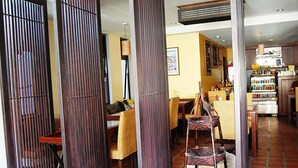 A restaurant with a traditional interior, featuring wooden furniture and a tiled floor. - Mandala House (Chiang Mai)