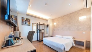 A modern hotel room with a bed, desk, chair, and a wardrobe. - Prescott Hotel Bukit Bintang (Kuala Lumpur)