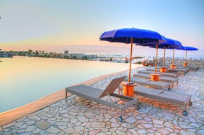 Seasonal outdoor pool, open 9:00 AM to 7:00 PM, pool umbrellas