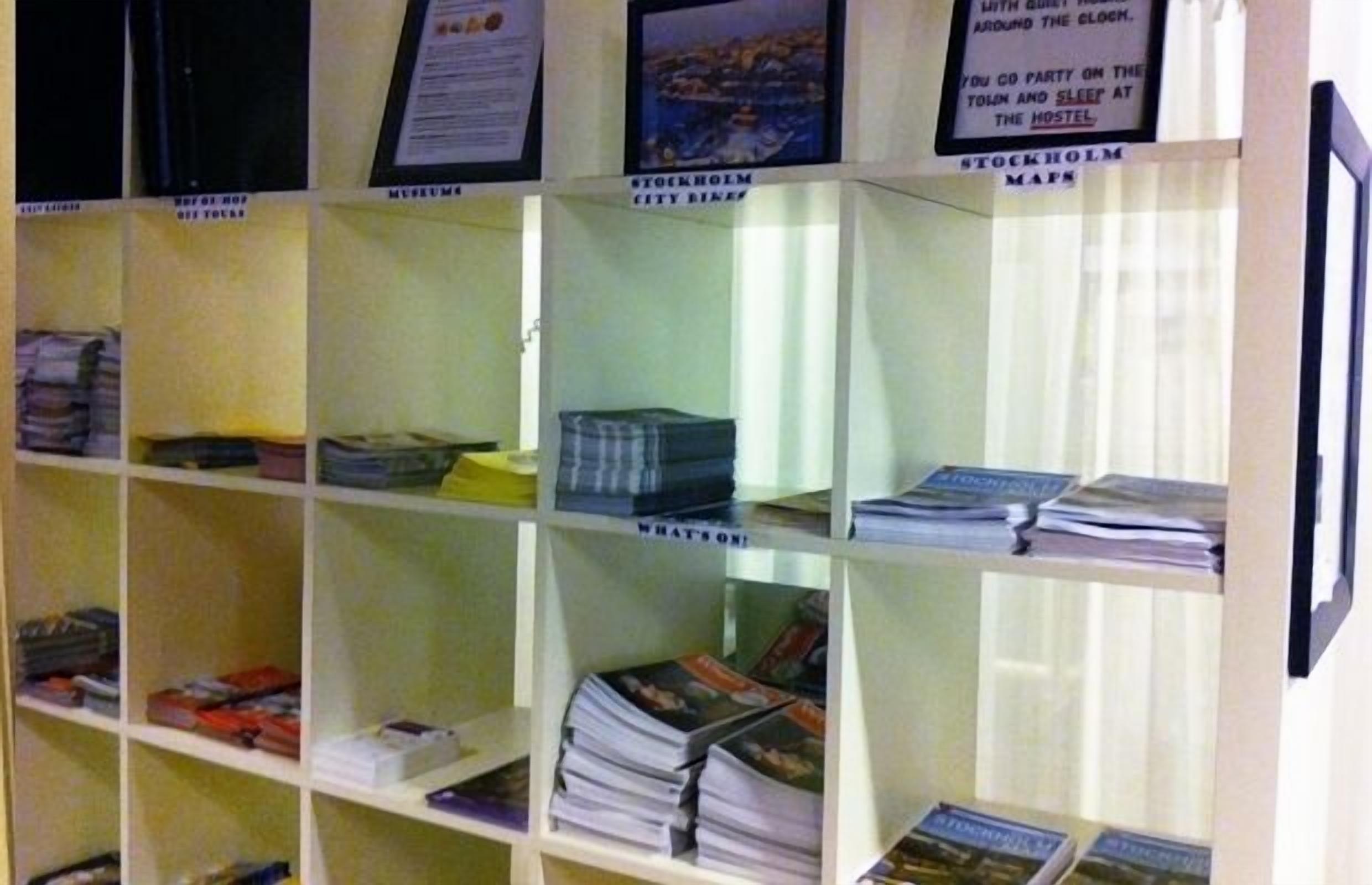 A library with bookshelves containing various books and pamphlets.