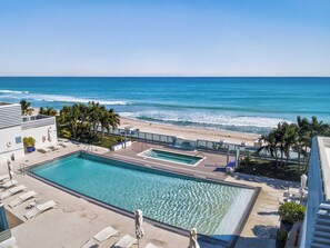 A pool area with a view of the beach and ocean. - Monte Carlo by Miami Vacations (Miami Beach)