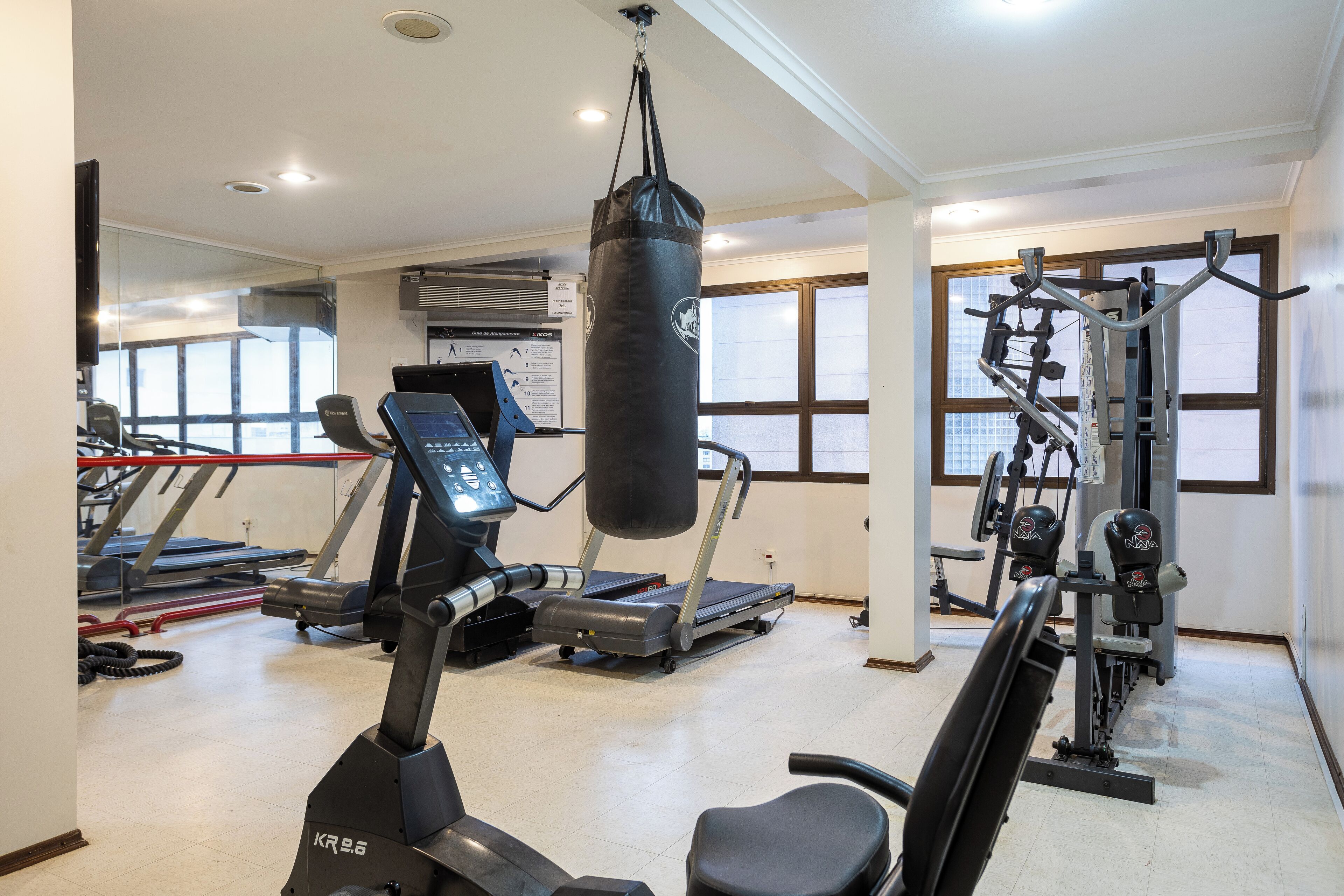 A gym with treadmills, a punching bag, and weight machines.
