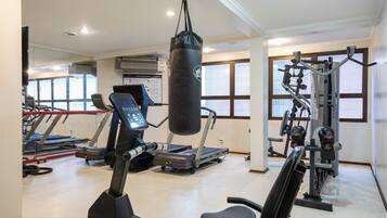 A gym with treadmills, a punching bag, and weight machines.