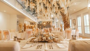A banquet hall with tables set for a formal event, featuring floral centerpieces and elegant table settings. - The Gibside Hotel (Newcastle-upon-Tyne)