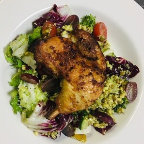 A plate of food with a roasted chicken, salad, and vegetables. - Holiday Inn Express Manchester Airport by IHG (Manchester)