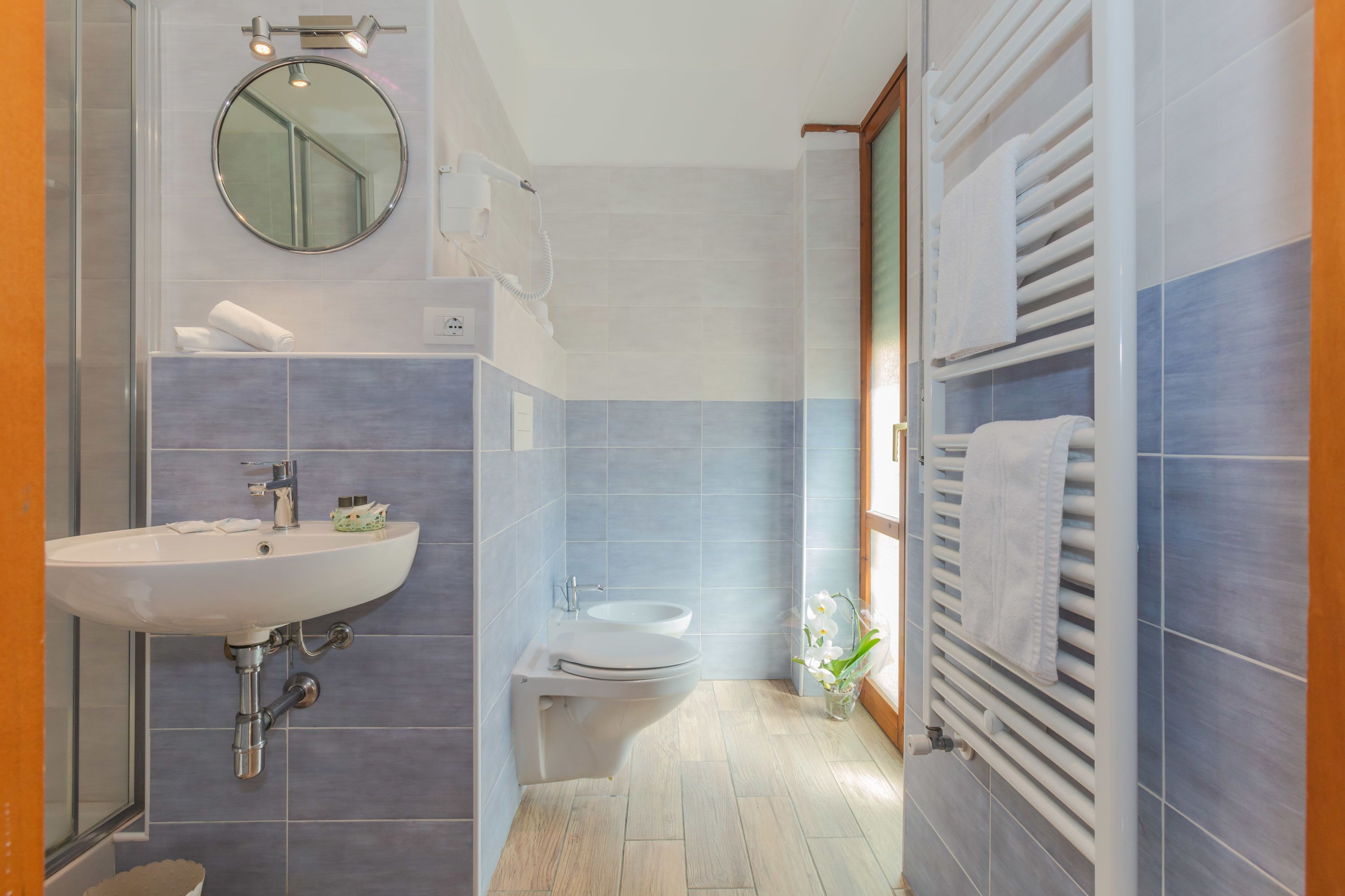 A modern bathroom with a sink, toilet, and shower.