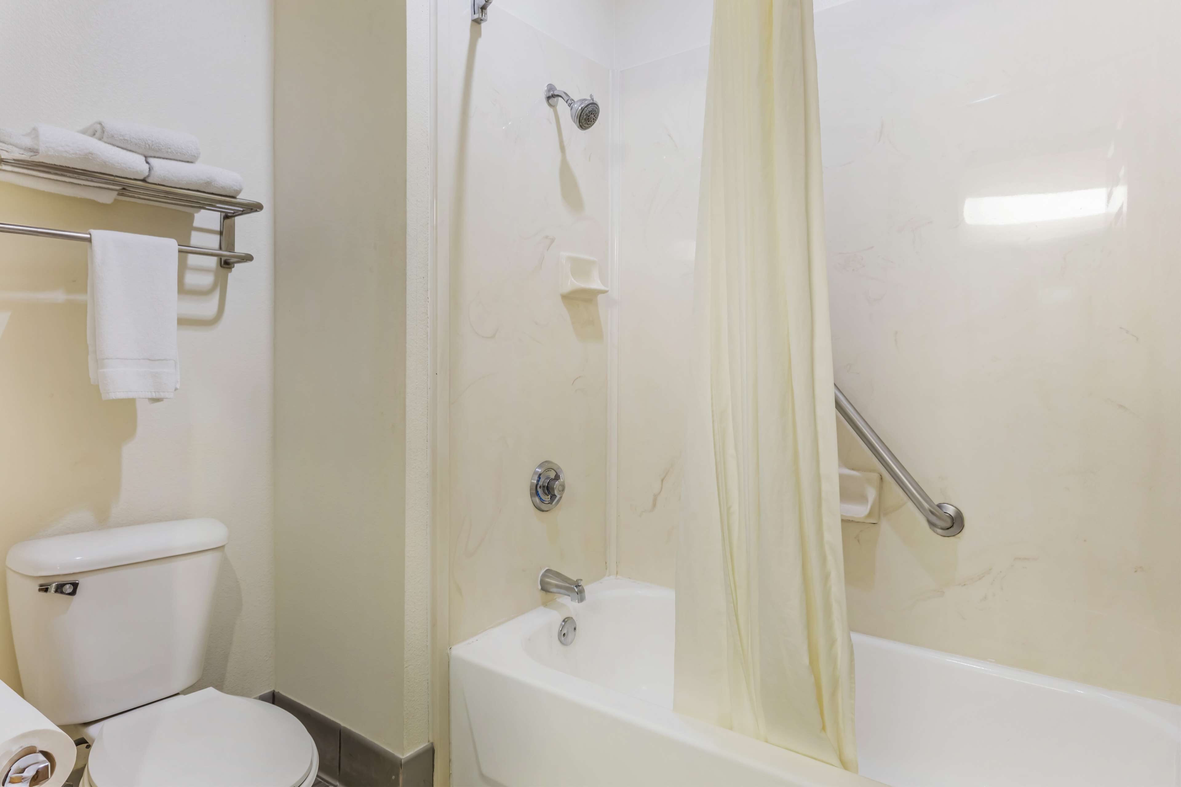 standard room, 2 queen beds, non smoking, refrigerator & microwave | bathroom | combined shower/bathtub, free toiletries, hair dryer, towels