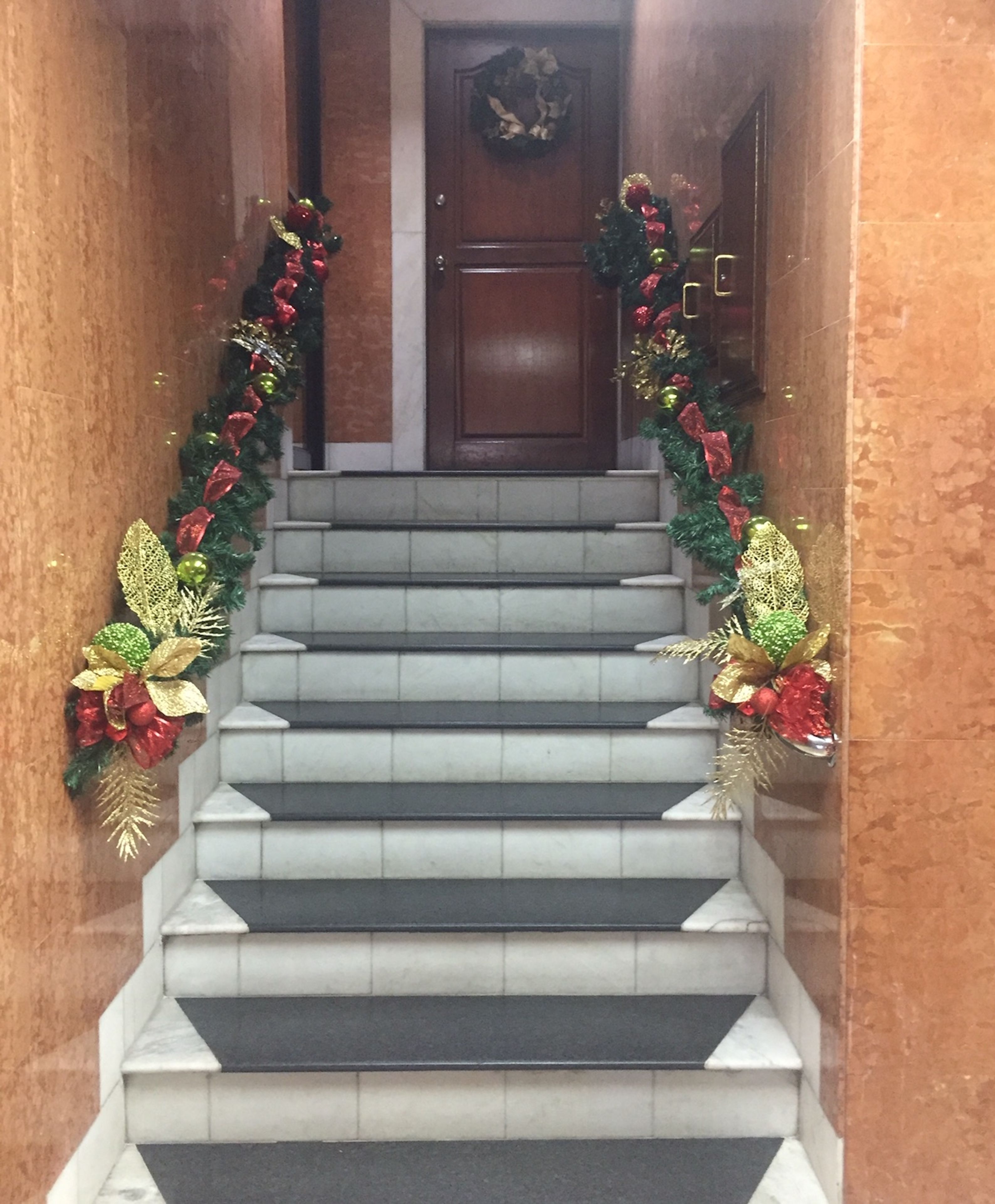 A staircase with a Christmas garland.
