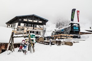 A snow-covered building with a sign reading "INFERNO BAR, TERRACE, REFUGE". - Inferno Morzine (Morzine)
