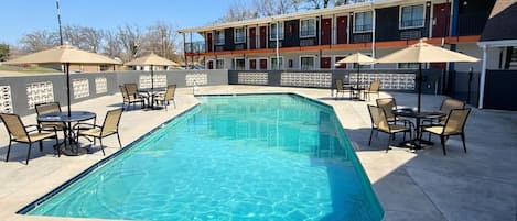 Alberca al aire libre y camastros