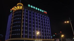 A hotel with a modern design, featuring a prominent sign with Chinese characters, multiple floors with evenly spaced windows, and a well-lit facade. - GreenTree Inn Shantou Chengjiang Road Business Hotel (Shantou)