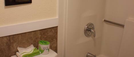 A bathroom with a toilet, a bathtub, and a shower.
