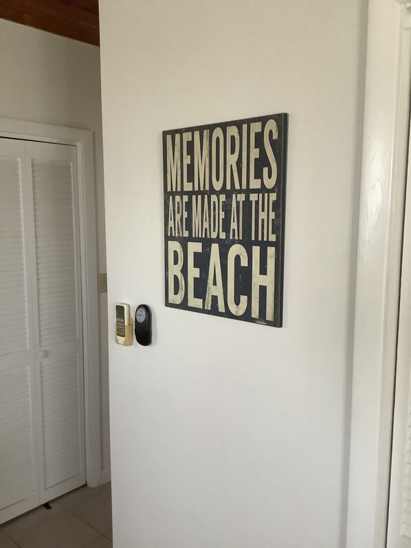 Una pared con un letrero que dice "MEMORIES ARE MADE AT THE BEACH".