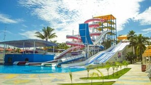 A water park with multiple water slides and a swimming pool. - Suites Princess (Bucerías)