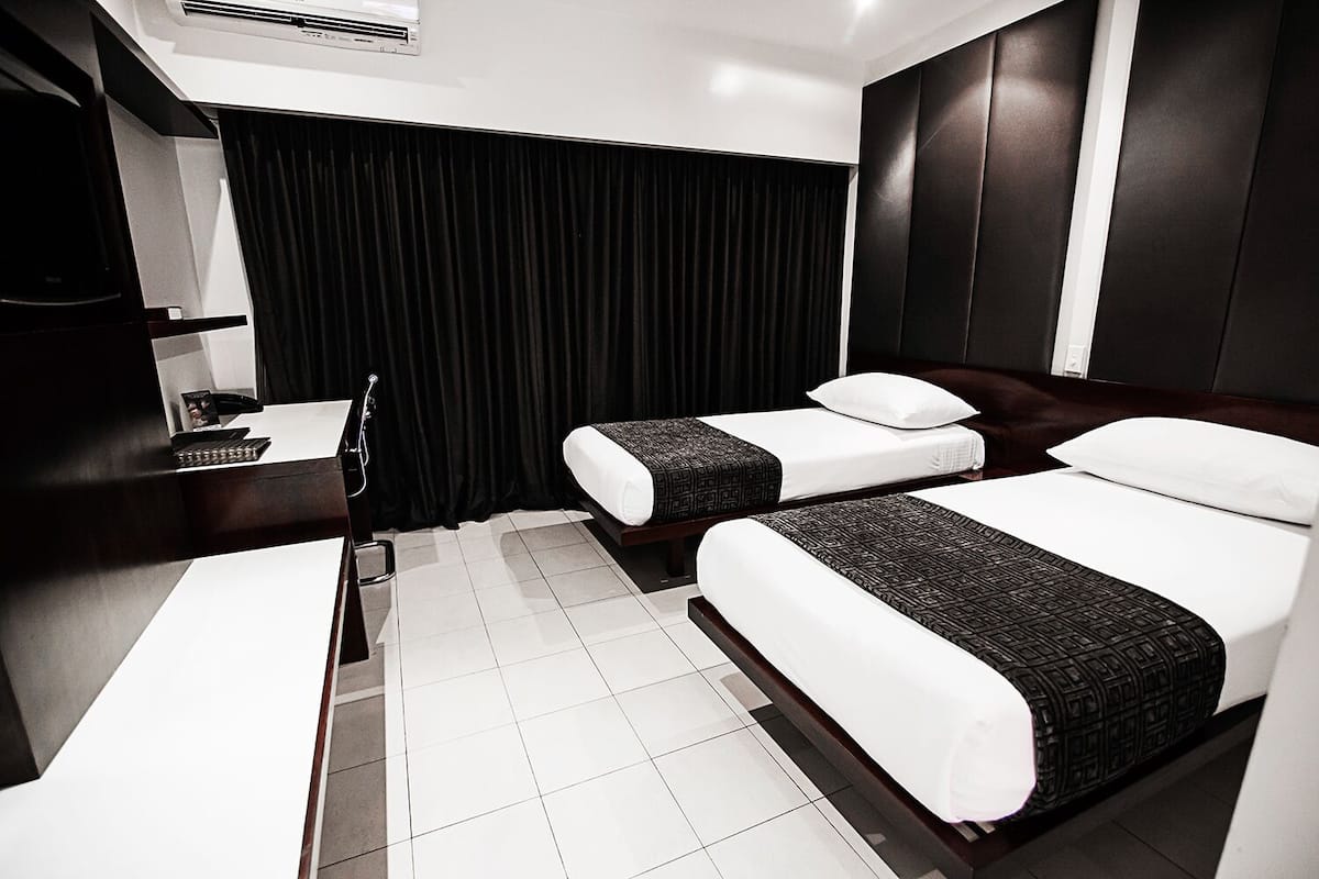 twin room | in-room safe, desk, laptop workspace, iron/ironing board