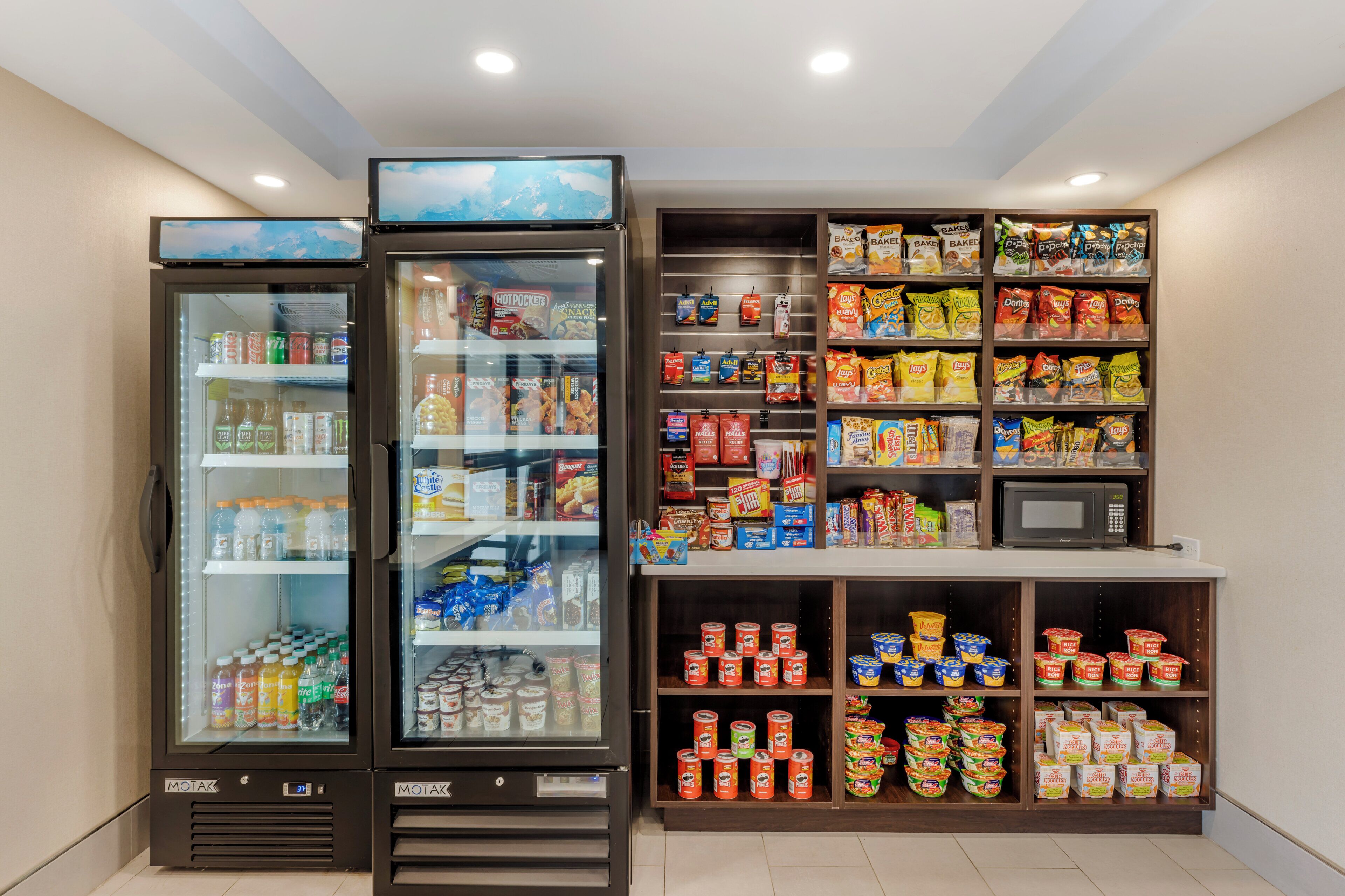 A vending machine area with various snacks, drinks, and frozen foods.