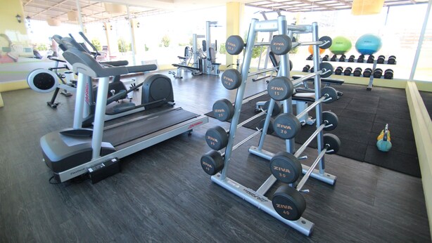 A gym with cardio equipment, weightlifting stations, and dumbbells. - The Icon Place at Central Pattaya (Pattaya)