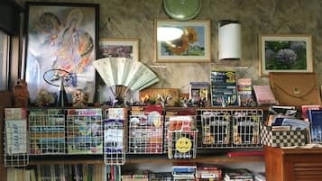 Cozy retreat with a personal touch, featuring a clock, framed artwork, and a collection of books and decorative items.