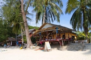 A beachside wooden structure with a thatched roof, surrounded by palm trees. - Salad Villa (Ko Pha-ngan)