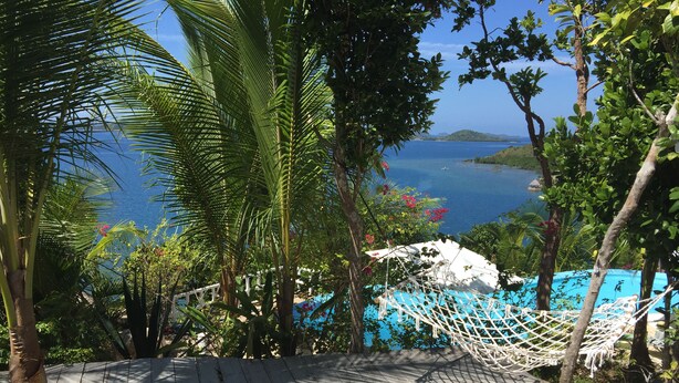 A wooden deck with a hammock and a white canopy, overlooking a body of water and a distant island. - Al Faro Cosmio Hotel (Busuanga)