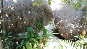 Thatched-roof huts surrounded by lush greenery. - Al Faro Cosmio Hotel (Busuanga)