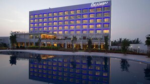 A hotel with a modern design, featuring a large pool in front. - Denissons (Hubli)
