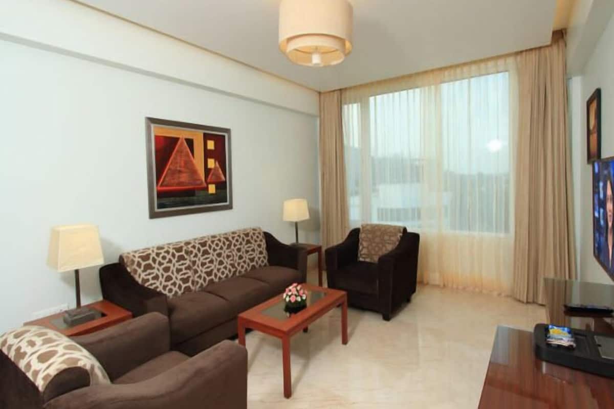 Junior Suite | Living area | 40-inch LED TV with cable channels, TV
