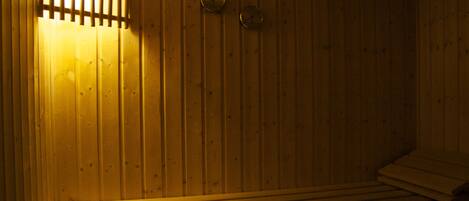 A sauna with wooden walls and benches.