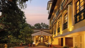A hotel entrance with a staircase leading to the main building, surrounded by potted plants and a red carpet. - Storii by ITC Hotels Shanti Morada Saligao, Goa (Saligao)