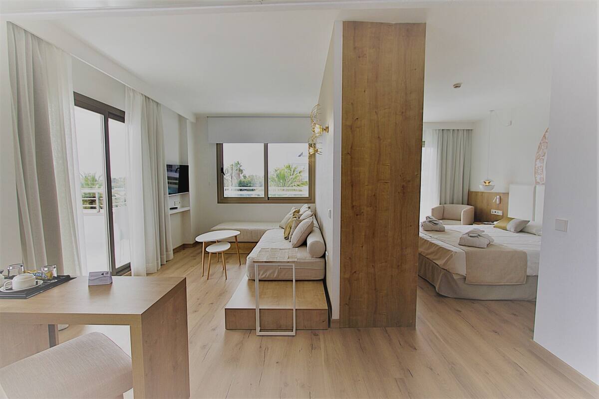 A modern living room with a wooden column, a sofa, a coffee table, and a TV.